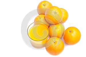 Fizzy orange juice from effervescent tablet with oranges at backdrop