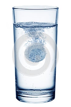 Fizzy pill in the glass of water. photo