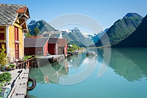 Fjord, mountains, boathouse and reflection in Norway