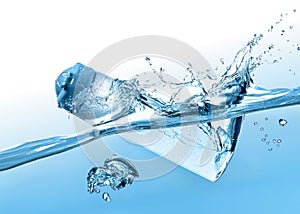 The flacon of moisturizing shampoo, cosmetic liquid, tonic falls into the blue water with big water splash