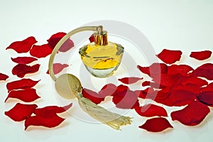 Flacon of perfume in red petals of roses