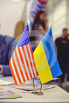 Flag of America and Ukraine on the table, business relations between countries