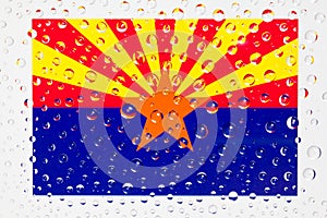 Flag of American State Arizona behind a glass covered with rain