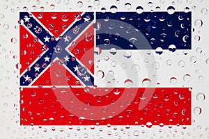 Flag of American State Mississippi behind a glass covered with r