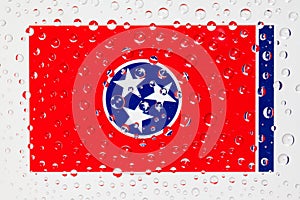 Flag of American State Tennessee behind a glass covered with rain drops.