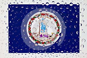 Flag of American State Virginia behind a glass covered with rain