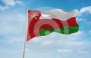 flag of Arab peoples Omanis at cloudy sky background, panoramic view.flag representing ethnic group or culture, regional