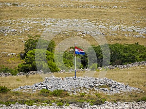 Flag on Archipelago - Islands of the Kornati archipelago panorama landscape of national park in Croatia view from the sea boat