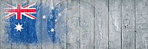 Flag of Australia. Flag is painted on a gray wooden plank surface. Wooden background. Plywood surface. Copy space. Textured