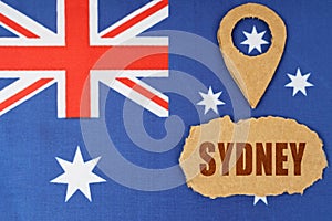 The flag of Australia has a geolocation symbol and a sign with the inscription - Sydney