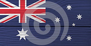 Flag of Australia on wooden wall background. Grunge Australian flag texture.