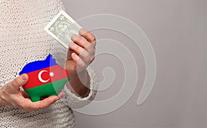 Flag of Azerbaijan on money bank in Azerbaijani woman hands. Dotations, pension fund, poverty, wealth, retirement concept