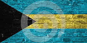Flag of Bahamas over an old brick wall background, surface