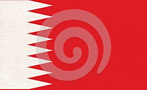 Flag of Bahrain on fabric surface. Bahraini national flag on textured background.