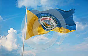 flag of Bandera Universidad Militar Nueva Granada , Colombia at cloudy sky background on sunset, panoramic view. Colombian travel photo