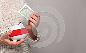 Flag of Belarus on money bank in Belarussian woman hands. Dotations, pension fund, poverty, wealth, retirement concept