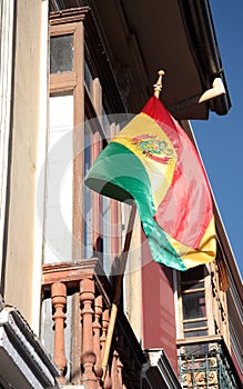 Flag of Bolivia at the window in La Paz