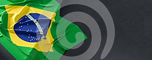 Flag of Brazil. Fabric textured Brazil flag isolated on dark background. 3D illustration