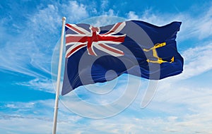 flag of British Royal Fleet Auxiliary Ensign at cloudy sky background on sunset, panoramic view. united kingdom of great Britain