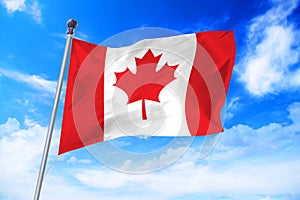 Flag of Canada developing against a blue sky