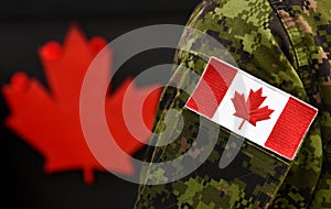 Flag of Canada on the military uniform and red Maple leaf on the background. Canadian soldiers. Army of Canada. Remembrance Day.
