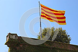 Flag of Catalonia on Montjuic castle, Barcelona, Spain