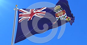 Flag of the Cayman Islands waving at wind with blue sky, loop