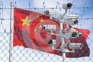 Flag of China behind barbed wire fence and cctv cameras. Concept of sanctions, dictatorship, discrimination and violation of human