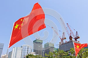 Flag of China in front of buildings under construction