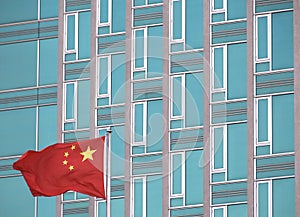 Flag of China with modern office building