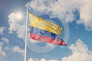 Flag of Colombia, National symbol waving against cloudy, blue sky, sunny day