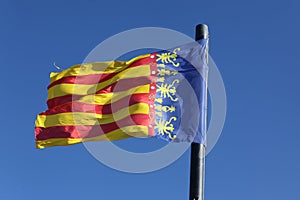 Flag of Comunidad Valenciana, region in Spain, moving in the win photo