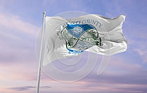 flag of county Garrett, Maryland , USA at cloudy sky background on sunset, panoramic view. Patriotic concept about Garrett,