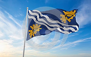 flag of county Merseyside , UK at cloudy sky background on sunset, panoramic view. County of united kingdom of great Britain,