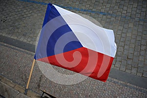 Flag of the Czech Republic on the building on the background of the sidewalk.
