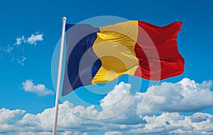 flag of Daco-Romance peoples Romanians at cloudy sky background, panoramic view. flag representing ethnic group or culture,