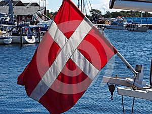 Flag of Denmark up high on a sail yacht