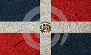 Flag of Dominican Republic on the sand. Sun and sea waves painted on the sand.