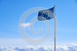 Flag of Europe against a clear blue sky.