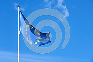 Flag of Europe against a clear blue sky.
