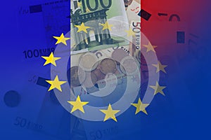 Flag of Europe and flag of France with euro notes and coins as a background