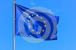 The flag of the European Union and the Council of Europe is a blue banner with 12 yellow stars forming a circle in the middle agai