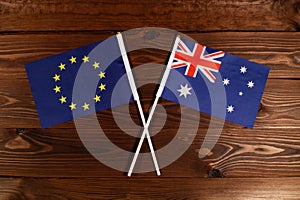 Flag of European Union and flag of Australia crossed with each other. The image illustrates the relationship between countries