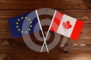 Flag of European Union and flag of Canada crossed with each other. The image illustrates the relationship between countries