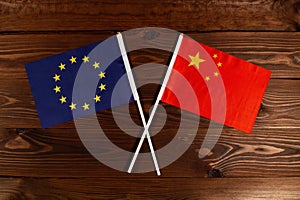 Flag of European Union and flag of China crossed with each other. The image illustrates the relationship between countries