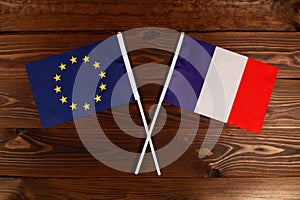 Flag of European Union and flag of France crossed with each other. The image illustrates the relationship between countries