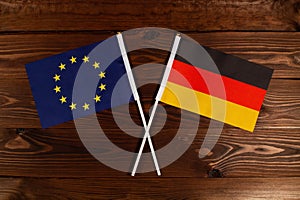 Flag of European Union and flag of Germany crossed with each other. The image illustrates the relationship between countries