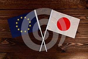 Flag of European Union and flag of Japan crossed with each other. The image illustrates the relationship between countries