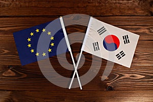 Flag of European Union and flag of South Korea crossed with each other. The image illustrates the relationship between countries