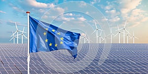 Flag of the European Union in front of solar panels and wind turbines